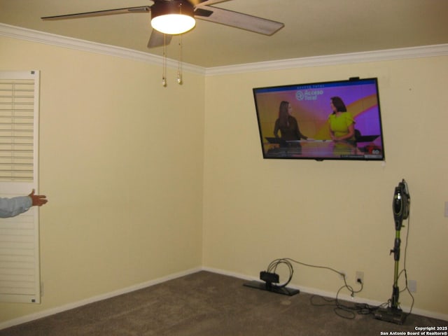 empty room featuring ceiling fan, dark carpet, and ornamental molding