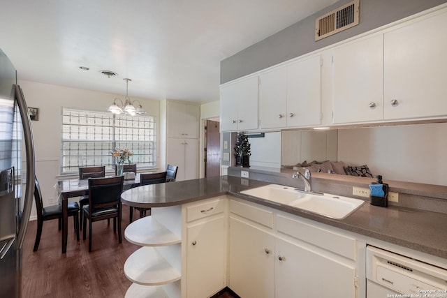 kitchen with sink, stainless steel refrigerator with ice dispenser, a notable chandelier, decorative light fixtures, and white cabinets