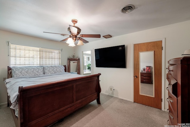 bedroom featuring light carpet and ceiling fan