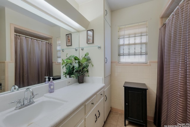 bathroom featuring vanity, tile patterned floors, and tile walls