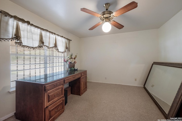 carpeted office with ceiling fan and a wealth of natural light