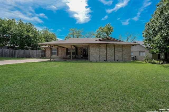 back of house with a lawn and central AC unit