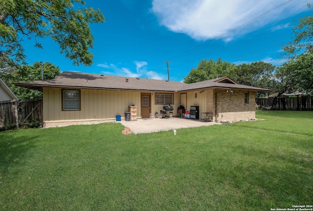 back of house featuring a patio and a lawn