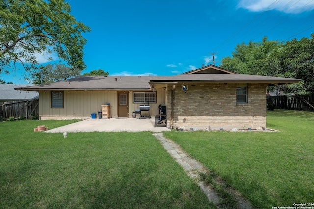 back of house with a yard and a patio area