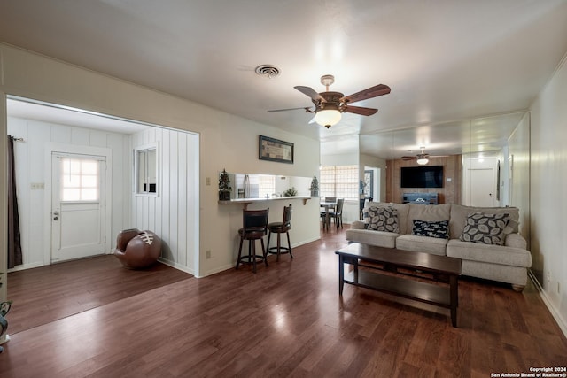 living room with ceiling fan, a healthy amount of sunlight, and dark hardwood / wood-style floors