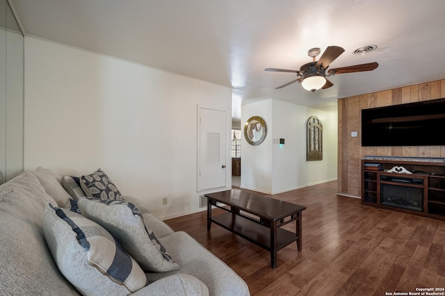 living room featuring ceiling fan and dark wood-type flooring