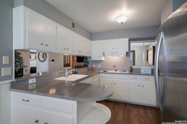 kitchen featuring white gas stovetop, white cabinets, sink, kitchen peninsula, and stainless steel refrigerator