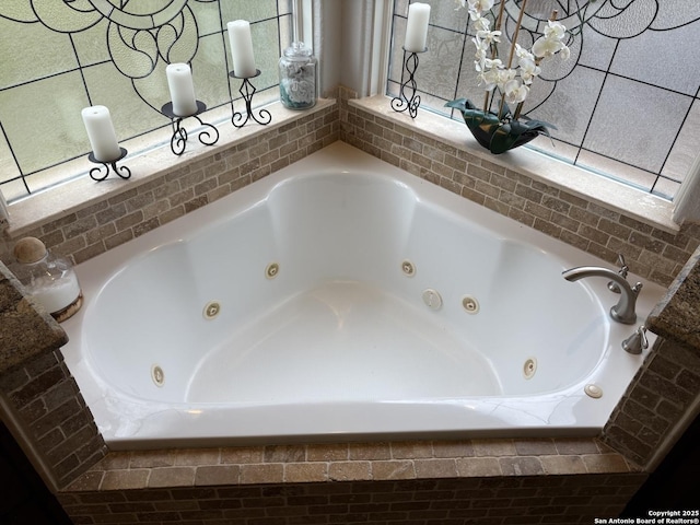 bathroom with a relaxing tiled tub