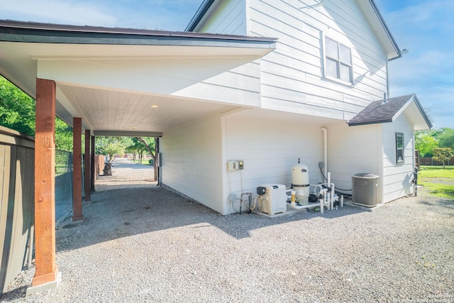 12007 Bobbi Way, San Antonio, TX 78245 - view of side of property featuring a carport, central air condition unit, and driveway