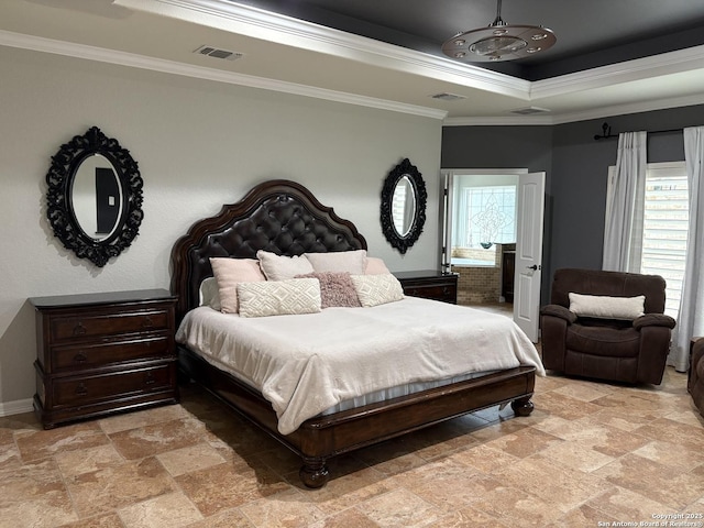 bedroom featuring a tray ceiling and ornamental molding