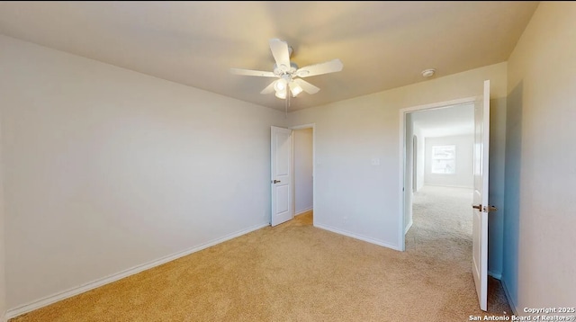 unfurnished bedroom featuring ceiling fan and light colored carpet