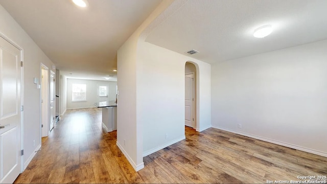 hallway with light hardwood / wood-style floors