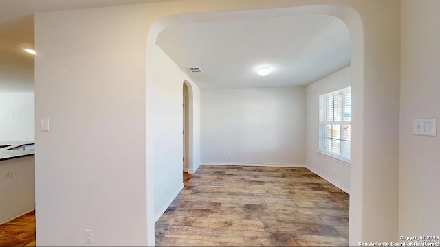 hall with hardwood / wood-style flooring