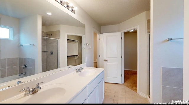 bathroom featuring tile patterned flooring, vanity, and an enclosed shower