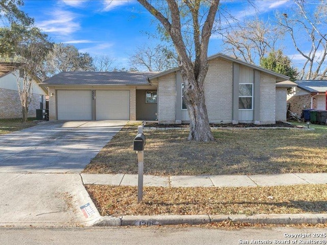 ranch-style house with central AC unit and a garage