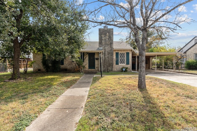 view of front of property with a front lawn and a carport