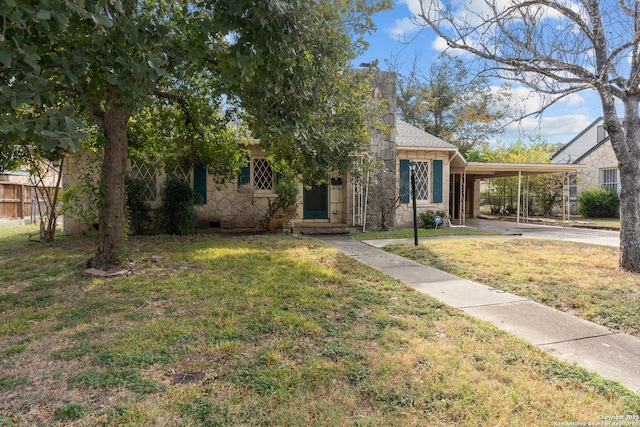 obstructed view of property with a carport and a front lawn