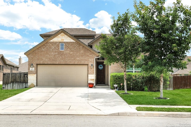 view of front of home with a garage and a front lawn