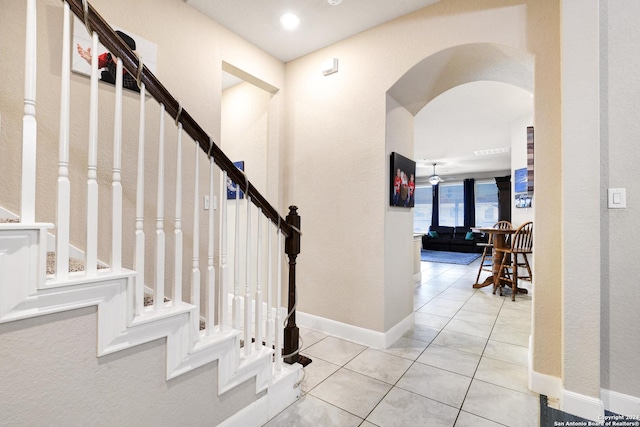 tiled foyer with ceiling fan