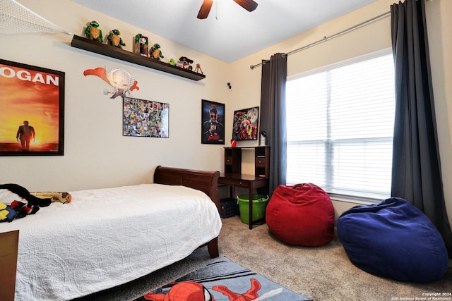 carpeted bedroom featuring multiple windows and ceiling fan