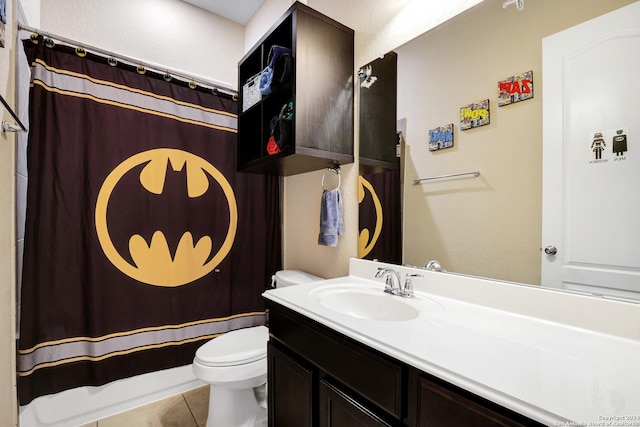 bathroom featuring tile patterned flooring, vanity, curtained shower, and toilet