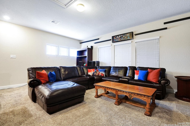 carpeted living room featuring a textured ceiling