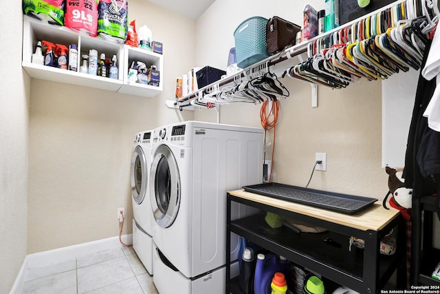 laundry room with washing machine and dryer and light tile patterned floors