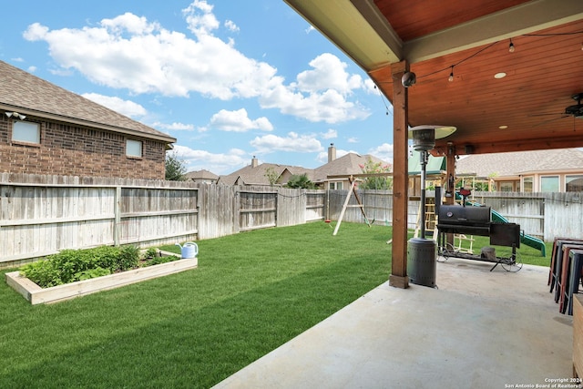 view of yard with a patio area and ceiling fan