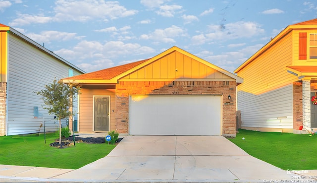 view of front of house with a garage and a front lawn