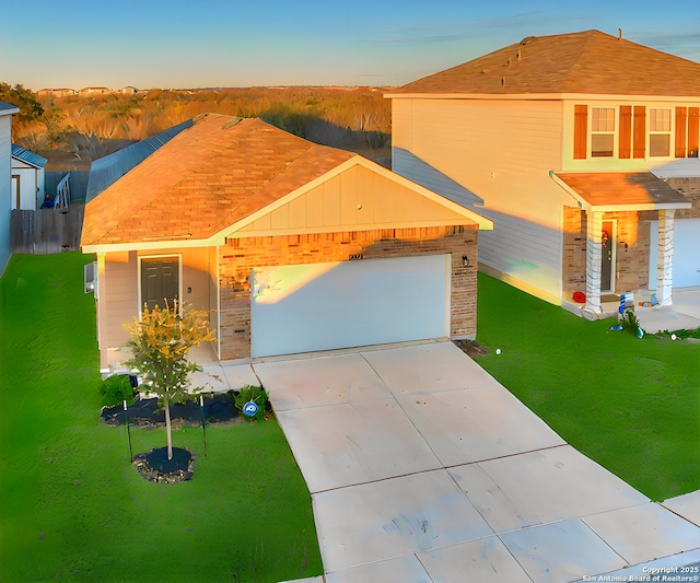 view of front facade featuring a garage and a lawn