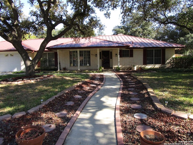 ranch-style house with a garage and a front lawn