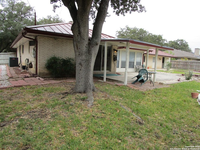 back of property with a yard, a patio, central AC, and ceiling fan