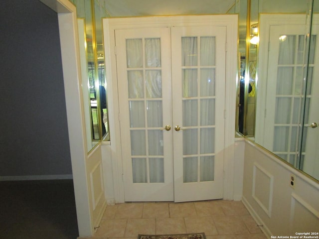 entryway with french doors and light tile patterned floors