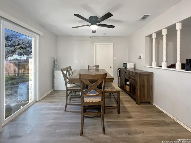 dining area with ceiling fan and hardwood / wood-style floors