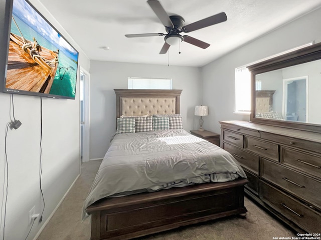 carpeted bedroom featuring ceiling fan and multiple windows