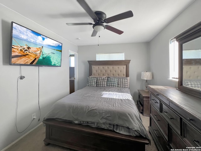 carpeted bedroom with ceiling fan and multiple windows