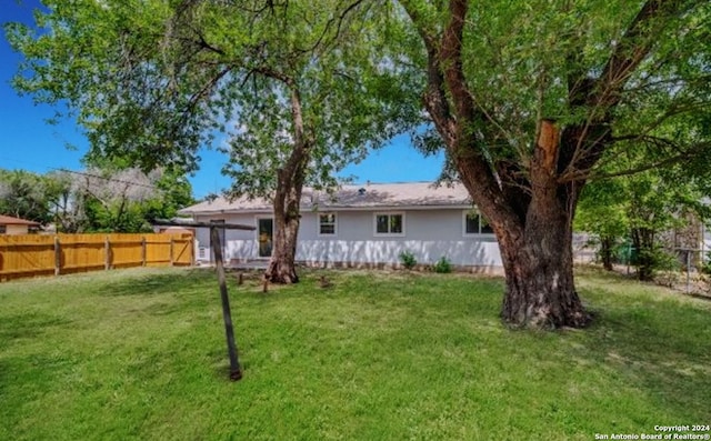 rear view of property with a lawn