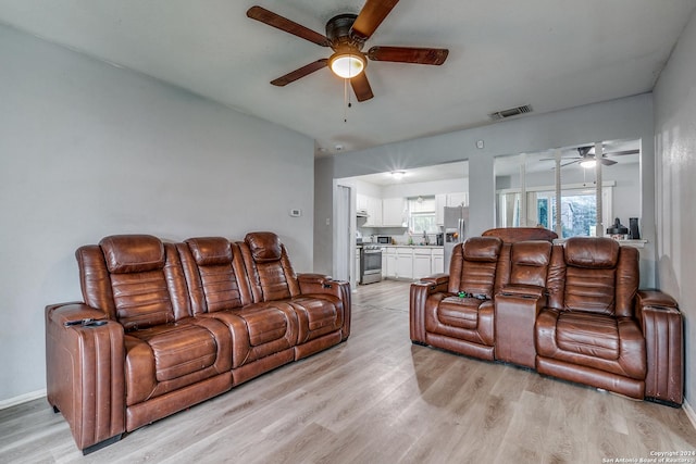 living room with sink and light hardwood / wood-style floors