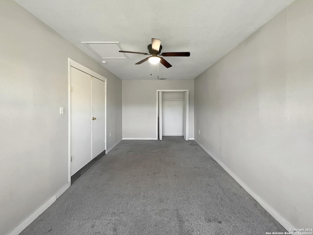 unfurnished bedroom featuring dark colored carpet and ceiling fan