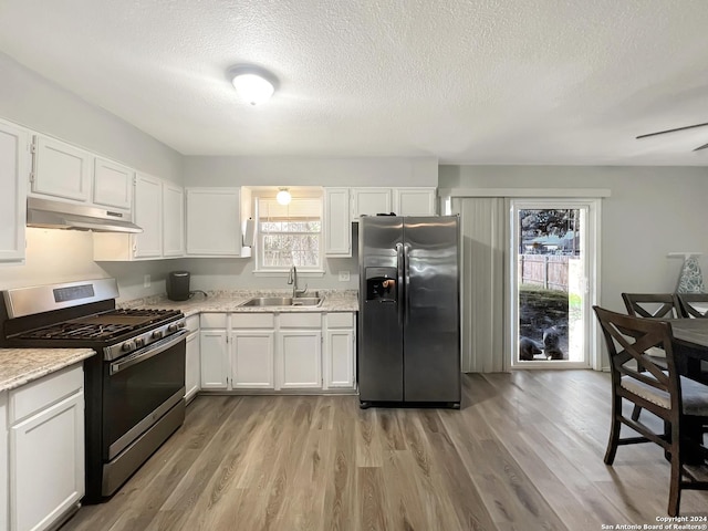 kitchen with white cabinets, a wealth of natural light, sink, and appliances with stainless steel finishes