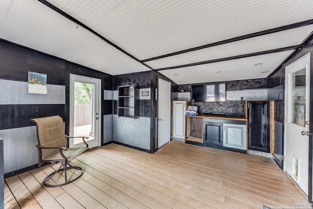 interior space with light wood-type flooring and vaulted ceiling