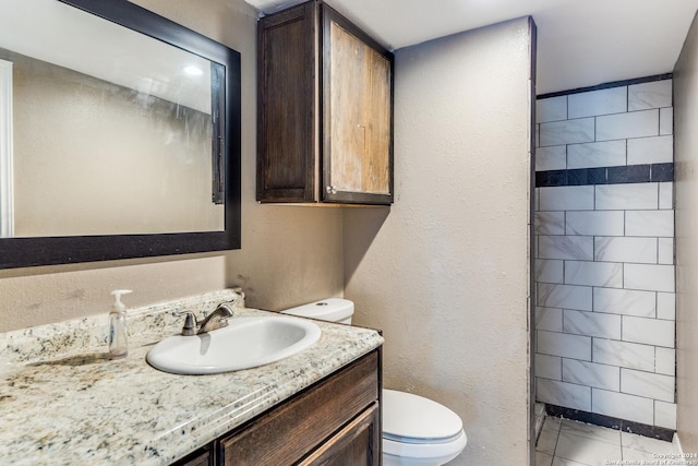 bathroom with tile patterned floors, vanity, and toilet