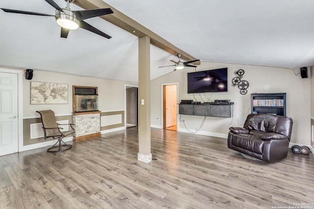 sitting room with hardwood / wood-style floors and vaulted ceiling with beams