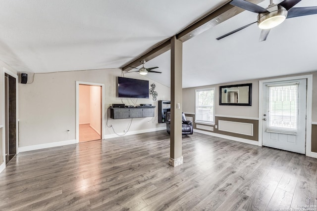 living room with lofted ceiling with beams, hardwood / wood-style flooring, and ceiling fan