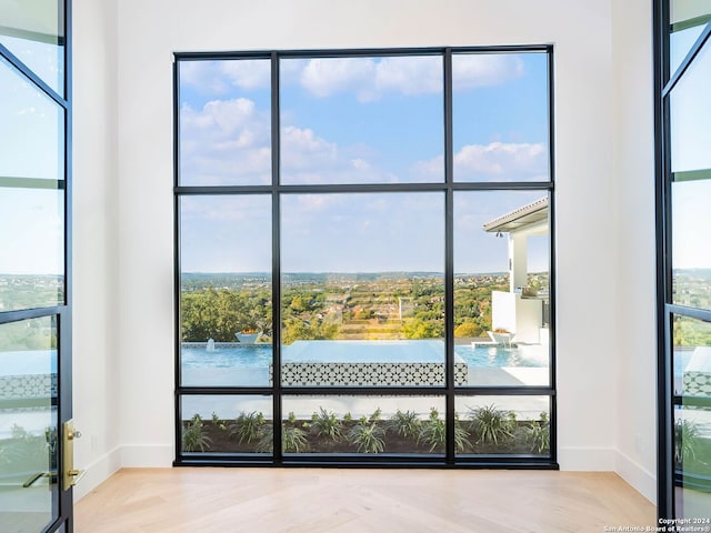 interior space featuring parquet flooring and a water view