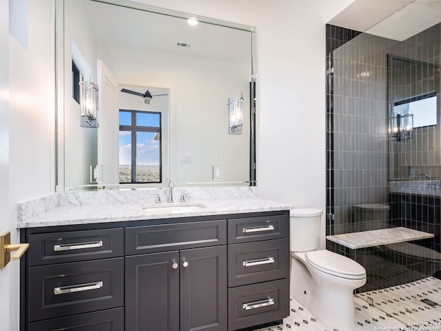 bathroom with tile patterned floors, vanity, toilet, and a shower with shower door