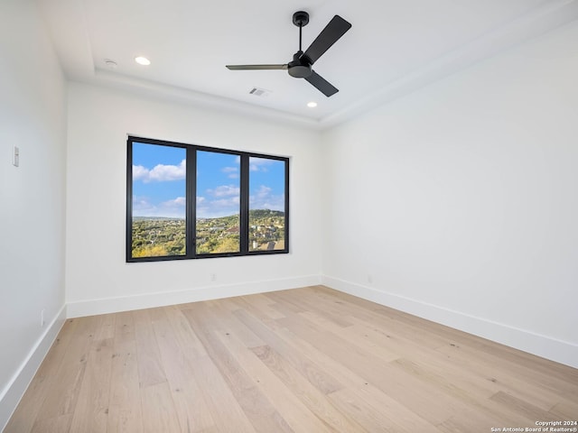 spare room featuring ceiling fan and light hardwood / wood-style floors