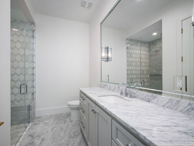 bathroom featuring vanity, toilet, and an enclosed shower