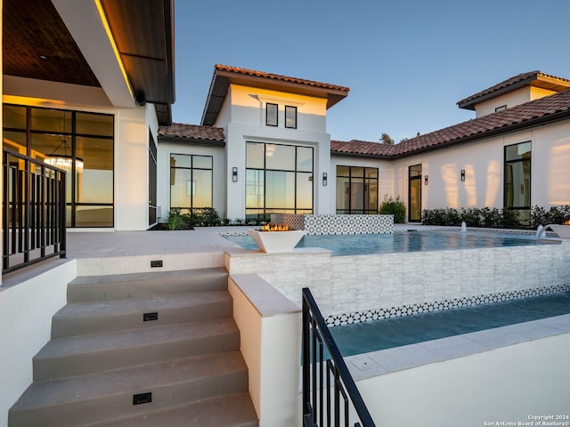 rear view of house with pool water feature