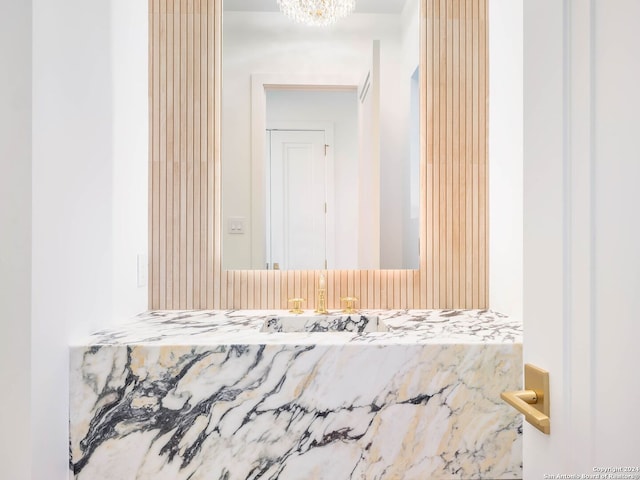 bathroom with vanity and a notable chandelier